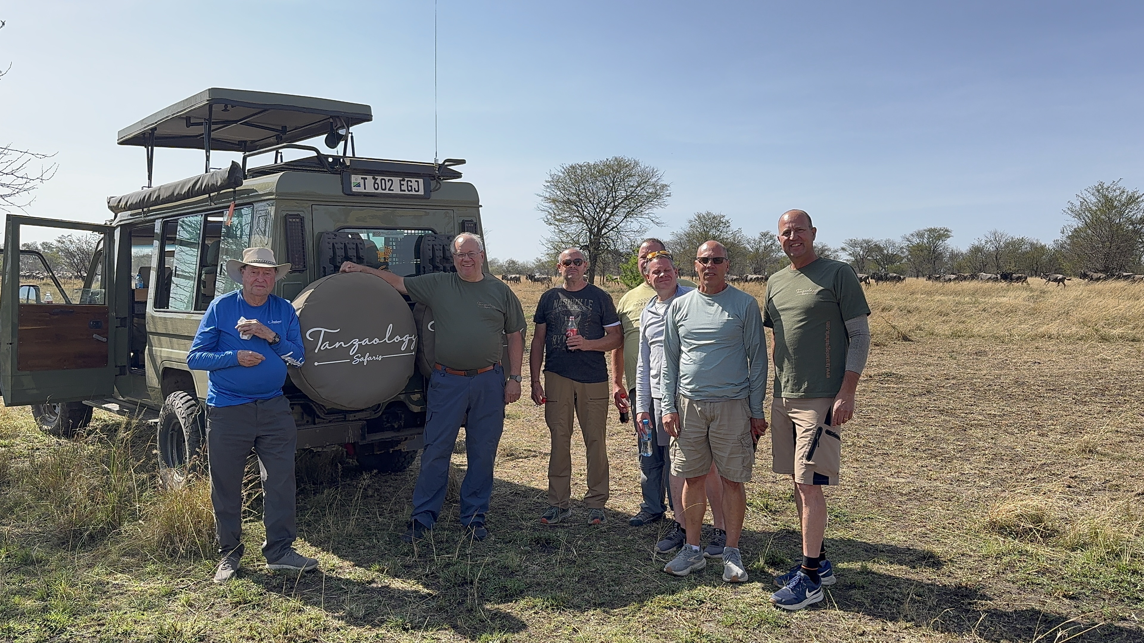 Guests and guides gathered in front of the safari fleet