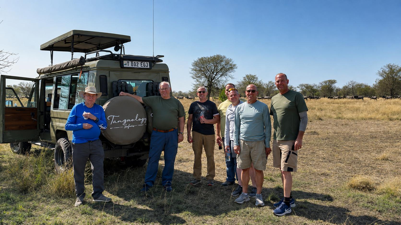 Tanzaology guests beside their branded safari vehicles