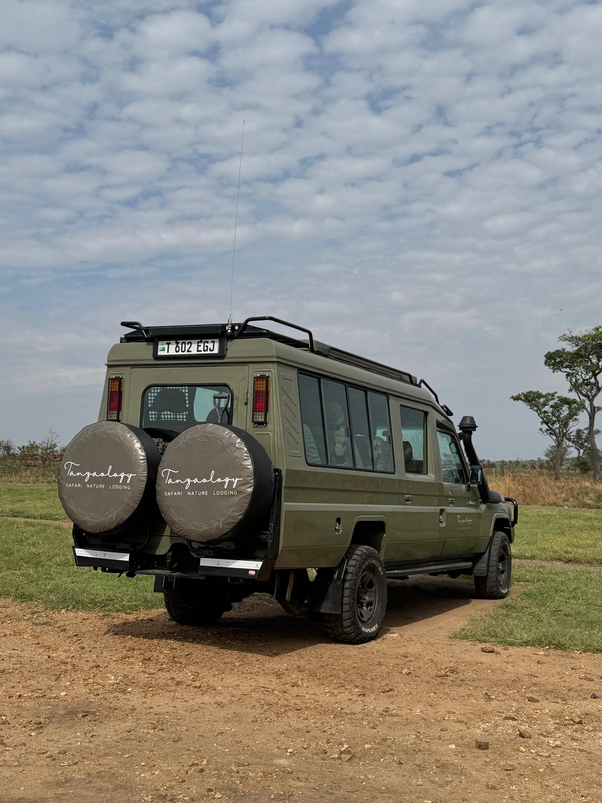 Rear view of a branded Tanzaology safari Land Cruiser