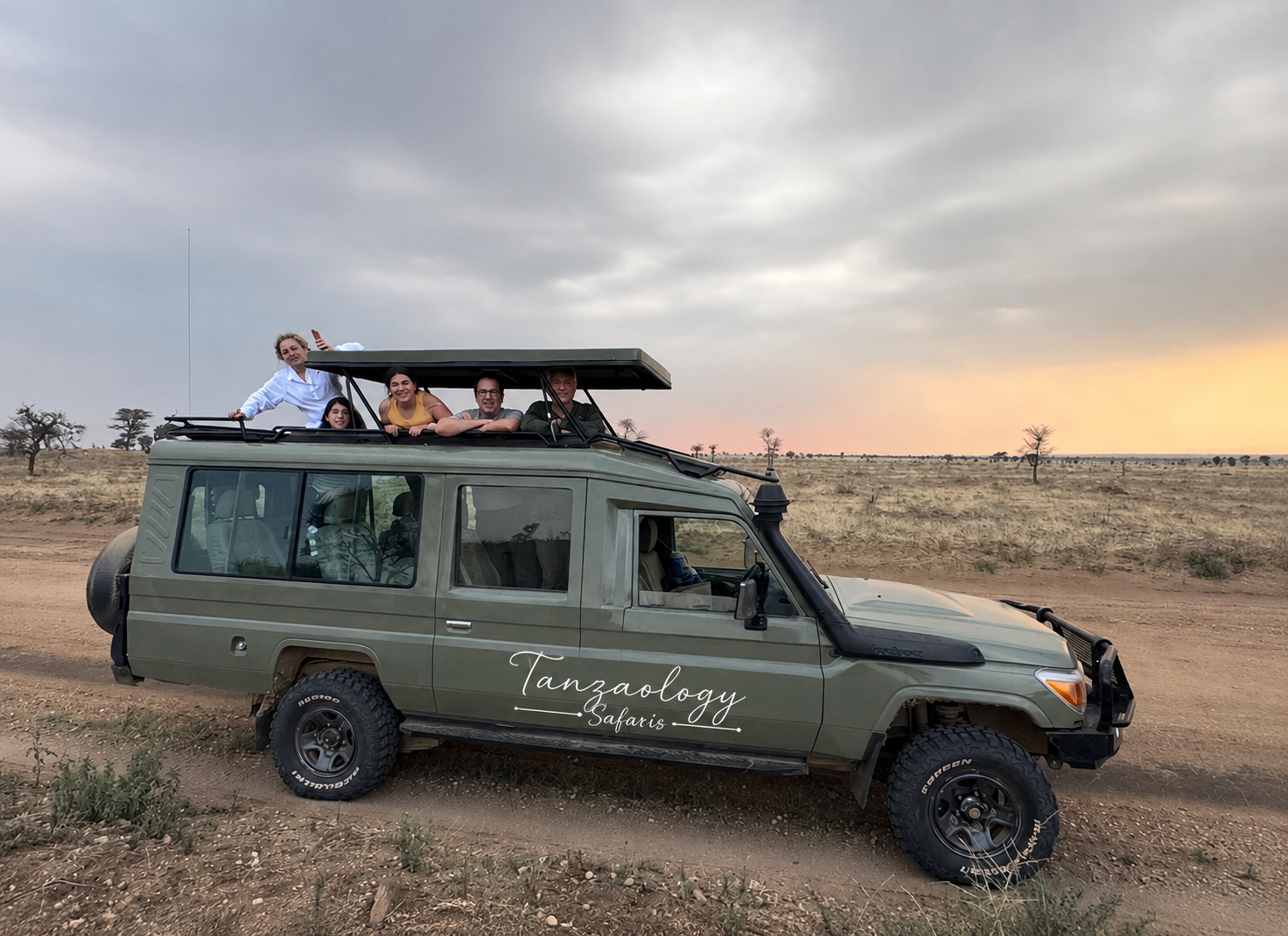 Tanzaology Land Cruiser with the roof up on the plains